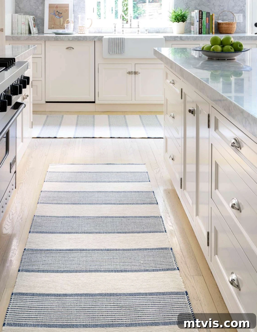 Designer Strategies for Stunning Kitchen Runner Rugs 7 Two striped cotton kitchen rug runners form a "T" in a white and marble modern kitchen.