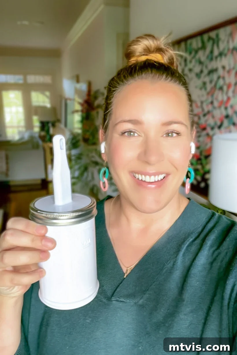 Master Wall Paint Touch Ups for a Flawless Finish 6 Tasha Agruso of Kaleidoscope Living holding Paint Saint can for paint touch ups
