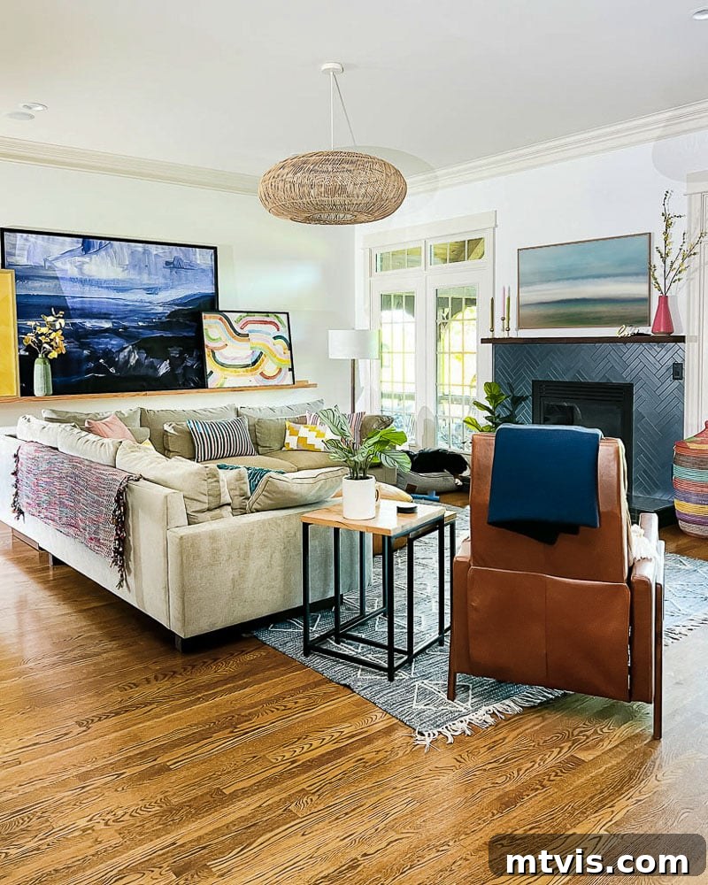 Mastering Flat Rugs Simple Solutions 3 Colorful living room featuring a tan sofa, large art on a ledge, and a blue and white area rug beautifully integrated into the space.