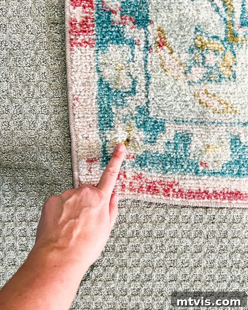 Mastering Flat Rugs Simple Solutions 8 Close-up photo of a rug corner screwed into carpet, illustrating the 'last resort' method for securing stubborn corners.