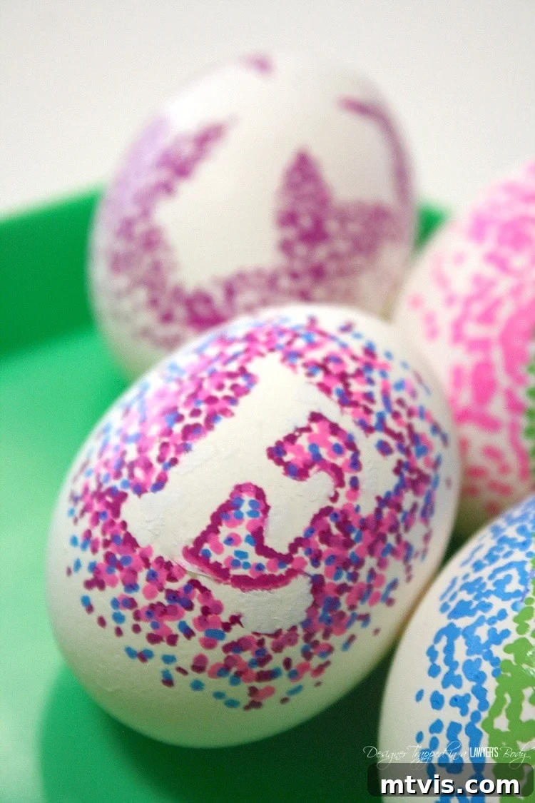 A cluster of artfully decorated Sharpie dotted Easter eggs displayed together, showcasing a variety of colors and sticker shapes, highlighting the diverse design possibilities.