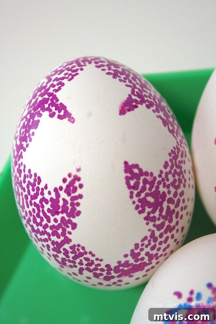 A close-up view of several dotted Sharpie Easter eggs, with some featuring solid-filled sticker voids and others left white, displaying the versatility of the decorating method.