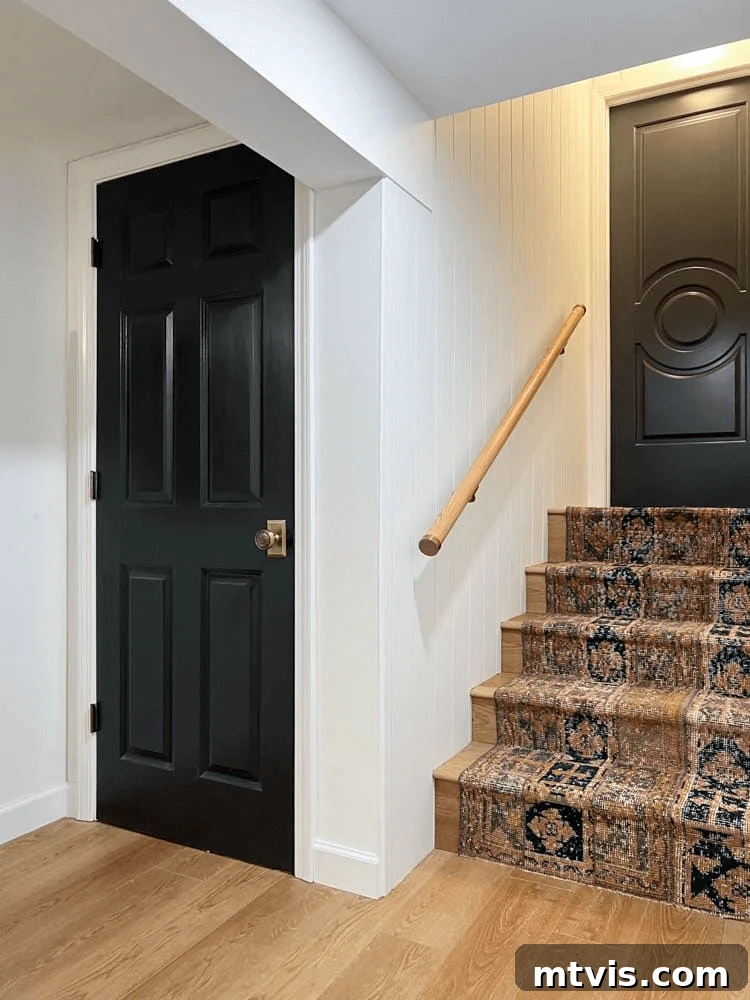 15 Stylish Stair Railing Concepts to Elevate Your Home 15 A wooden handrail has brass accents and an antique-style runner for a warm and fun staircase.