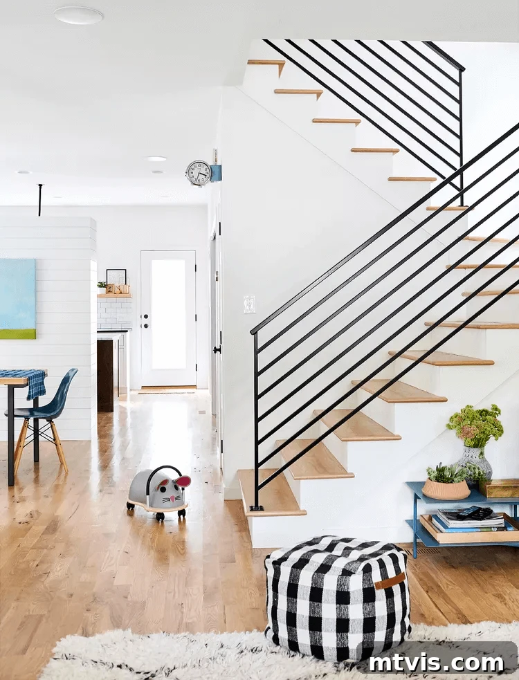 15 Stylish Stair Railing Concepts to Elevate Your Home 7 Black horizontal stair railings update a home with a more open feel.
