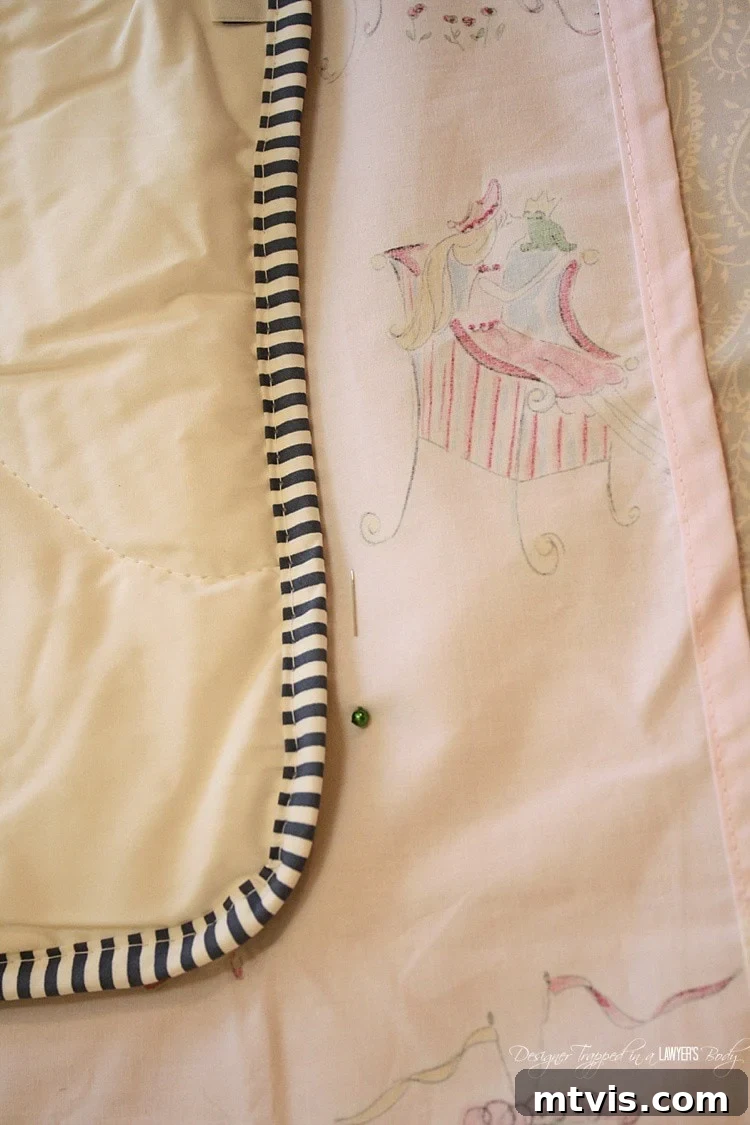 Pinning the flat sheets along the comforter's edges for sewing guidance