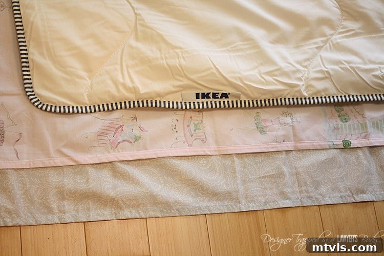 Laying flat sheets with right sides together, aligning comforter for cutting