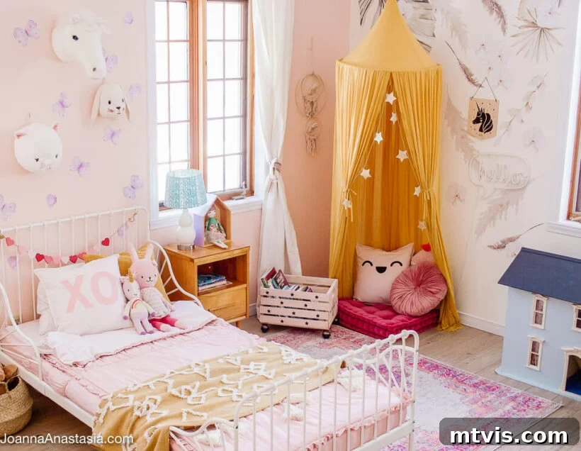 28 Whimsical Wonderland Bedrooms for Her 11 feminine little girls room with white iron toddler bed and reading nook with canopy