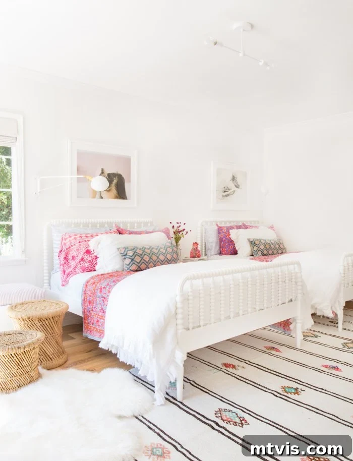 28 Whimsical Wonderland Bedrooms for Her 8 minimal shared girls bedroom with two double beds with white bedspreads and bright pops of pink