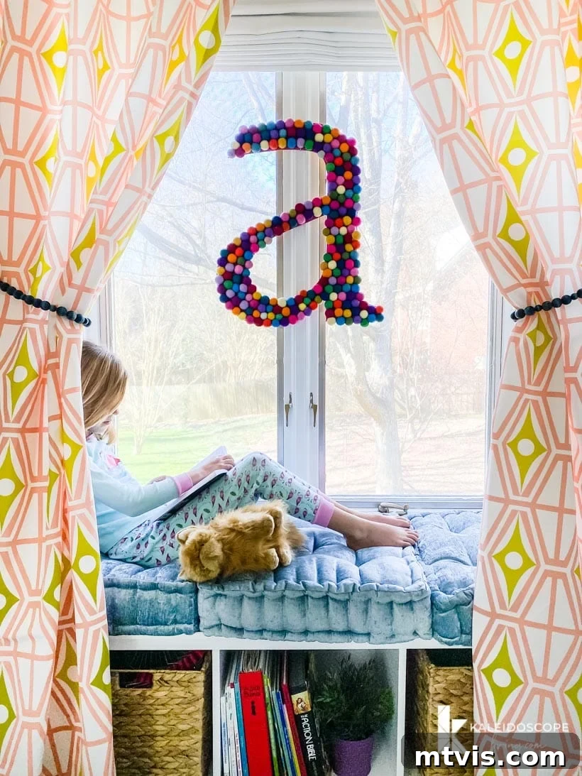 Supersize Your Walls With DIY Letters 10 Cozy reading nook framed by curtains in a colorful girl's bedroom featuring Attley's wall letter