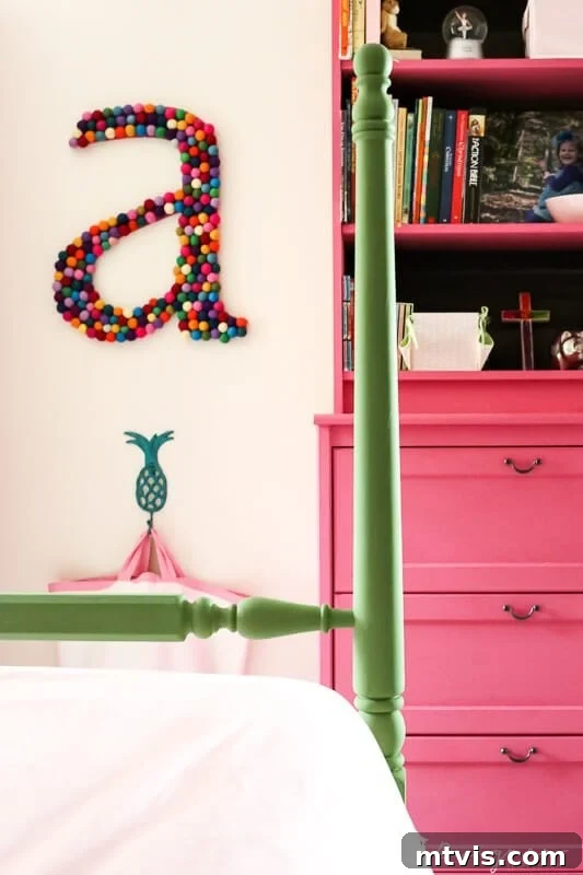 Supersize Your Walls With DIY Letters 11 Large colorful DIY wall letter 'A' hanging prominently in a pink and green girl's bedroom