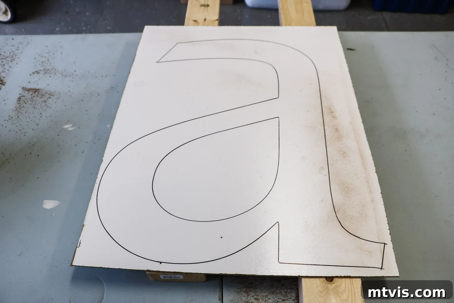 Large letter 'A' traced onto hardboard, ready for cutting