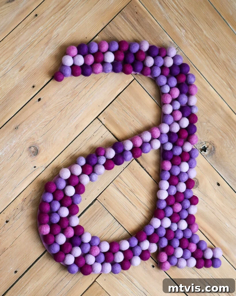 Supersize Your Walls With DIY Letters 8 Unique large DIY wall letter with a custom color scheme, adorned with felt balls