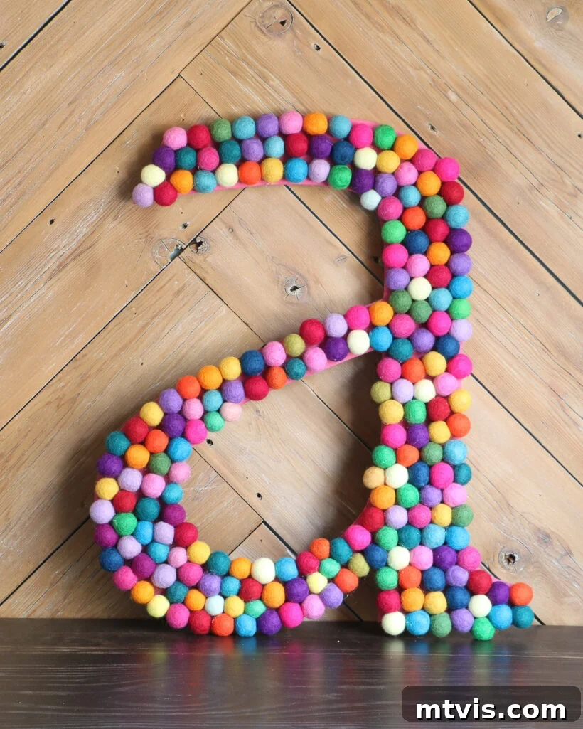 Supersize Your Walls With DIY Letters 9 Colorful large DIY wall letter made with an array of felt balls, showcasing vibrant personalization