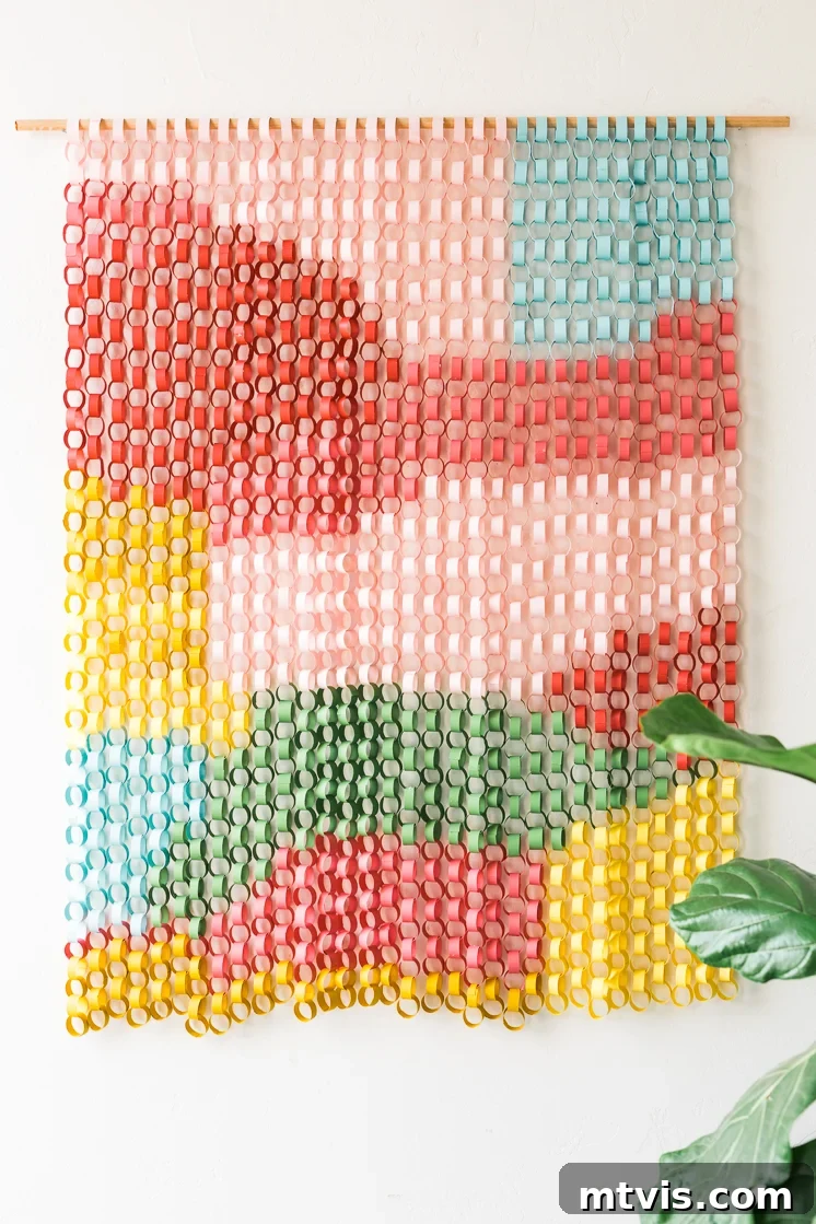 23 Ingenious DIY Wall Art Projects 13 A unique and modern paper chain wall hanging, beautifully crafted to add texture and artistic flair to contemporary interior decor.