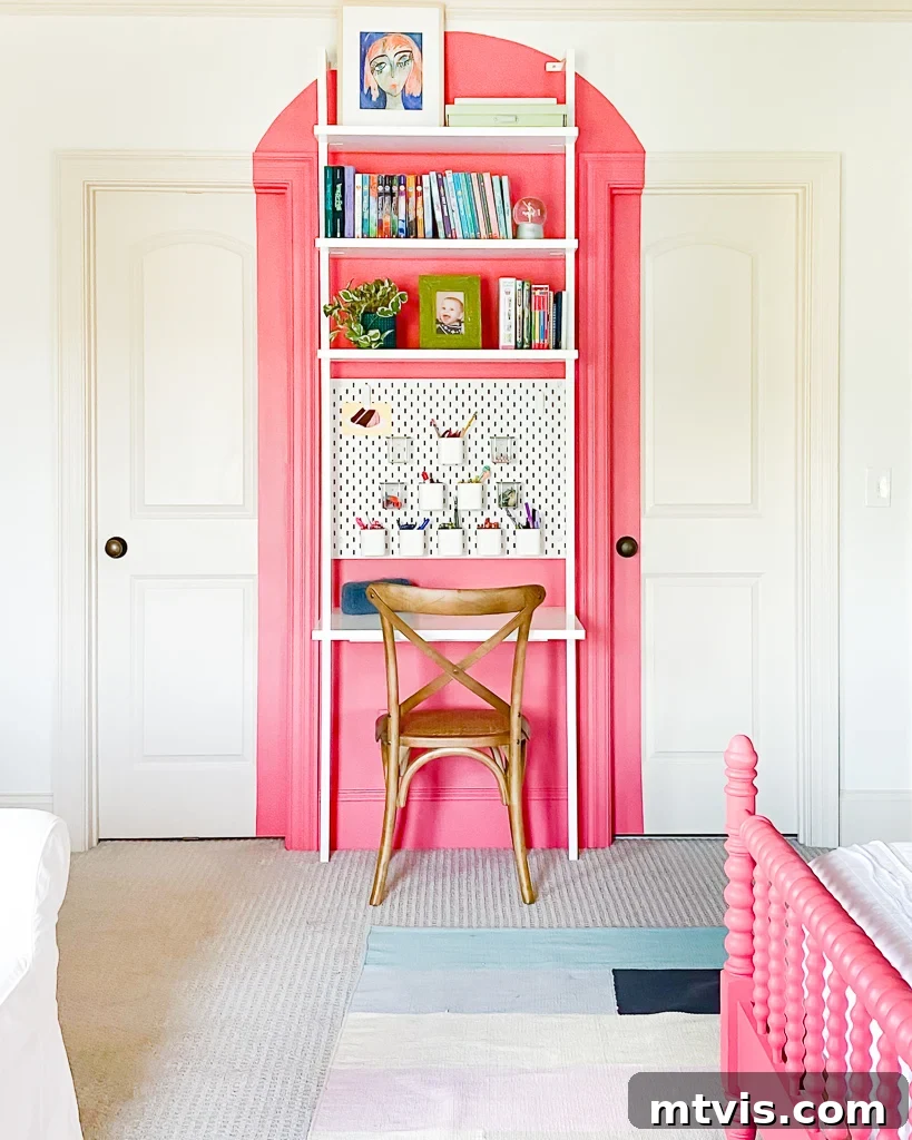 23 Ingenious DIY Wall Art Projects 14 A vibrant coral arch painted on a wall behind a sleek wall-mounted desk, complemented by a stylish wood chair, creates a lively workspace.