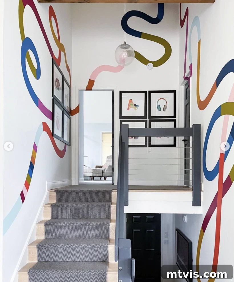 23 Ingenious DIY Wall Art Projects 16 A vibrant stairwell featuring a striking floor-to-ceiling color-blocked squiggle wall mural, bringing dynamic energy and modern art to the space.