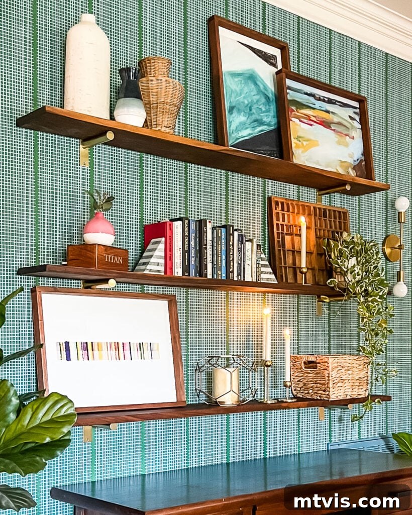 23 Ingenious DIY Wall Art Projects 21 Stylish DIY wall shelves, thoughtfully styled with a collection of books and hanging art, set against a modern green and white wall.