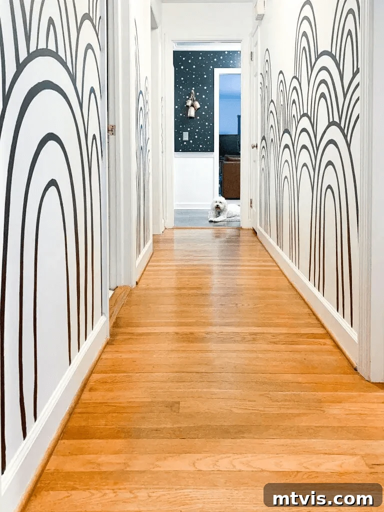 23 Ingenious DIY Wall Art Projects 22 A stylish hallway featuring a striking black and white rainbow mural, hand-painted with graphic precision, creating a modern and artistic accent.