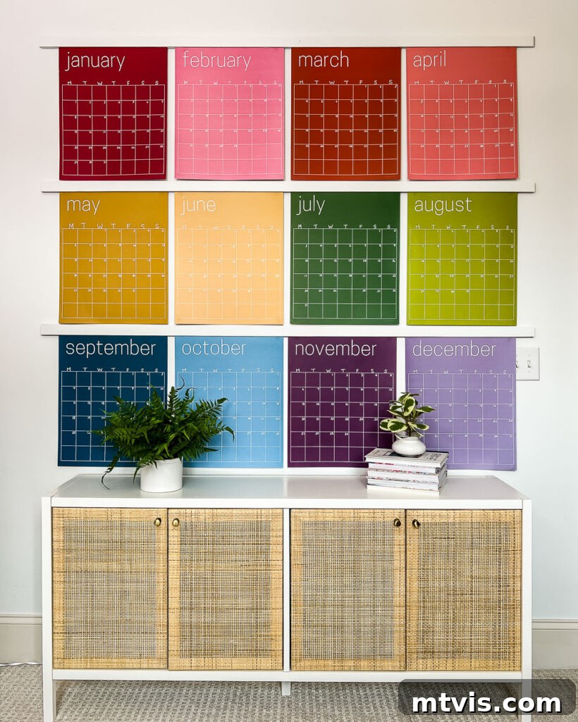 23 Ingenious DIY Wall Art Projects 6 A wall adorned with giant rainbow wall calendars neatly hung above a cabinet, offering both vibrant decor and practical organization.