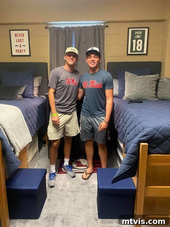 roommates standing in front of dorm beds with blue bedding, demonstrating coordinated dorm decor