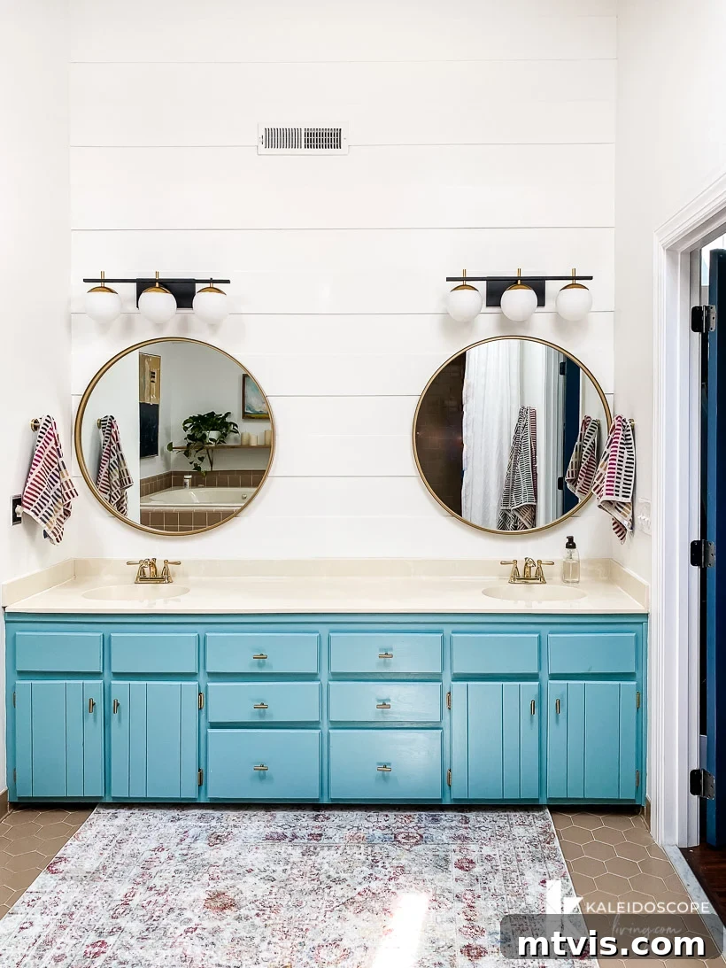 15+ Ingenious DIY Bathroom Renovation Ideas That Won't Break the Bank 13 blue vanity in master bathroom with updated plank wall, showcasing a modern transformation
