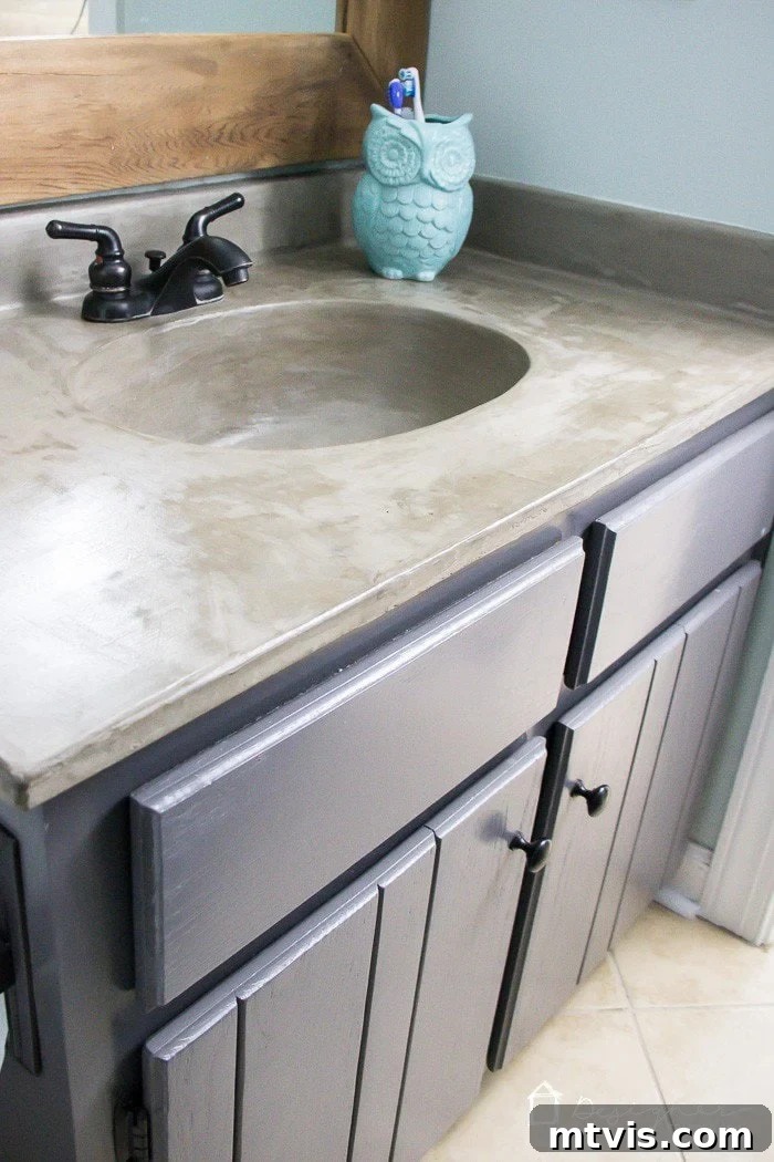 15+ Ingenious DIY Bathroom Renovation Ideas That Won't Break the Bank 8 vanity updated with concrete overlay on countertop and in sink, providing a modern industrial look