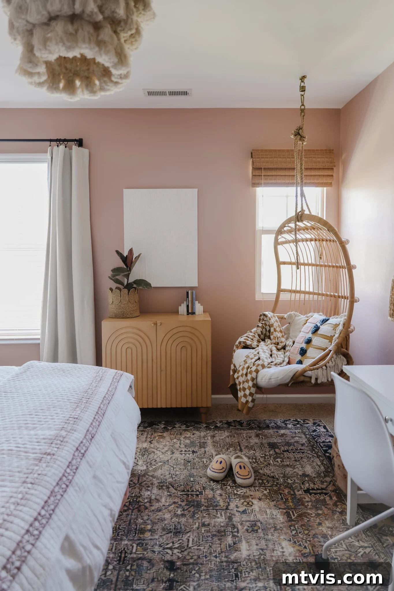 25 Creative Bedroom Transformations for Teenagers 20 The corner of a teen girl's neutral-colored room with a hanging basket chair, cabinet wall unit and white bed and desk.