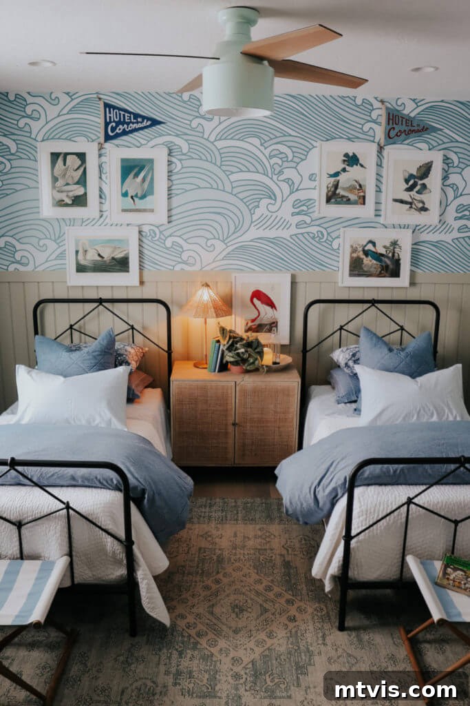 Brilliant Shared Kids' Bedroom Hacks 15 blue wave wallpaper with metal beds with blue and white bedding and bird prints over beds
