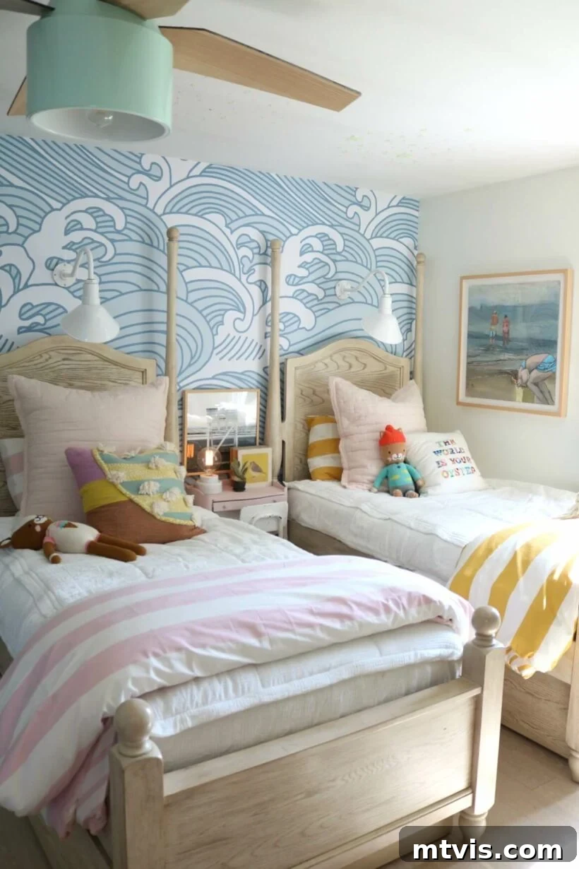 Brilliant Shared Kids' Bedroom Hacks 25 beds with colorful stuffed animals and striped blankets in front of wave wallpaper with colorful