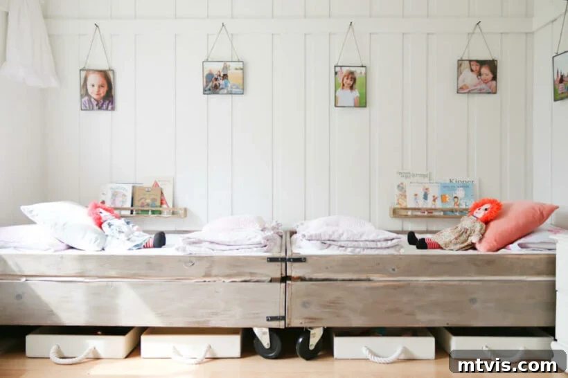 Brilliant Shared Kids' Bedroom Hacks 8 rustic wood beds on caster in white bedroom with hanging photographs over beds
