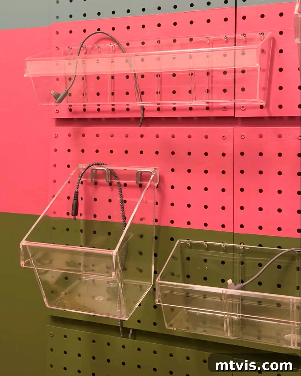 Charging cords neatly routed behind pegboard panels for a clean and organized look