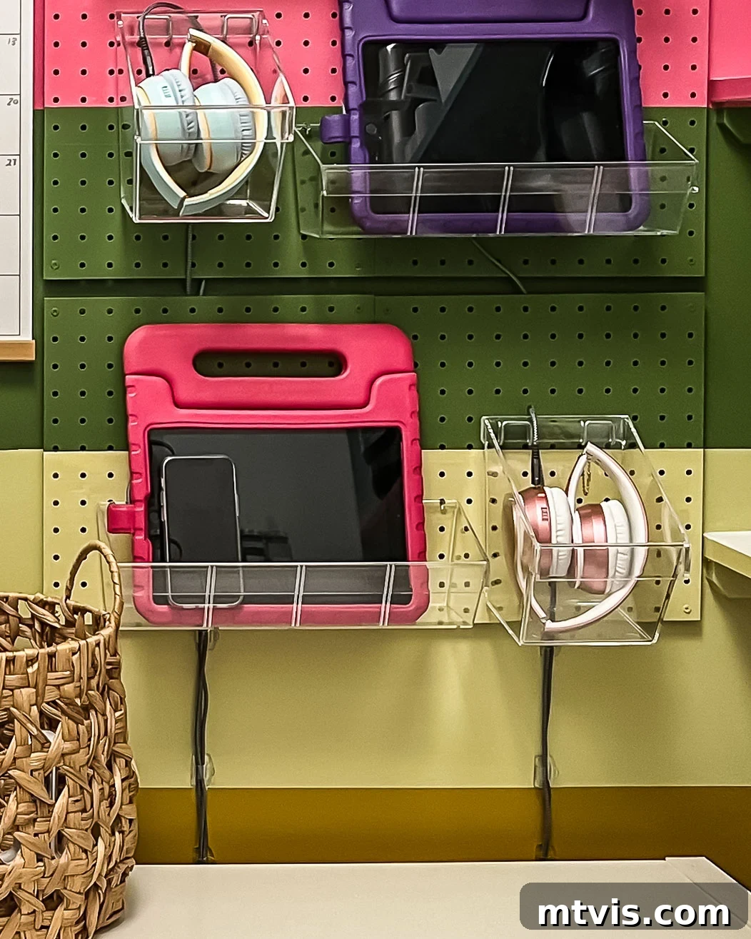 Close-up of Command Cord Clips used to neatly manage cables beneath the pegboard charging station