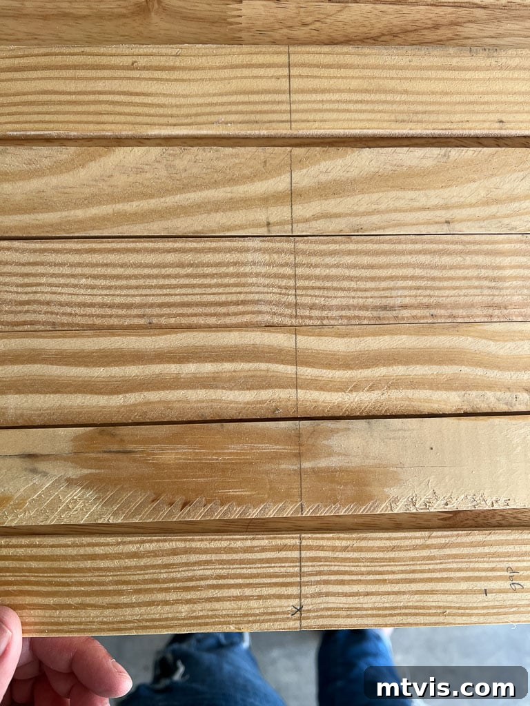 Lattice strips with pencil marks indicating precise magnet spacing and vertical placement for DIY magnetic poster hangers.