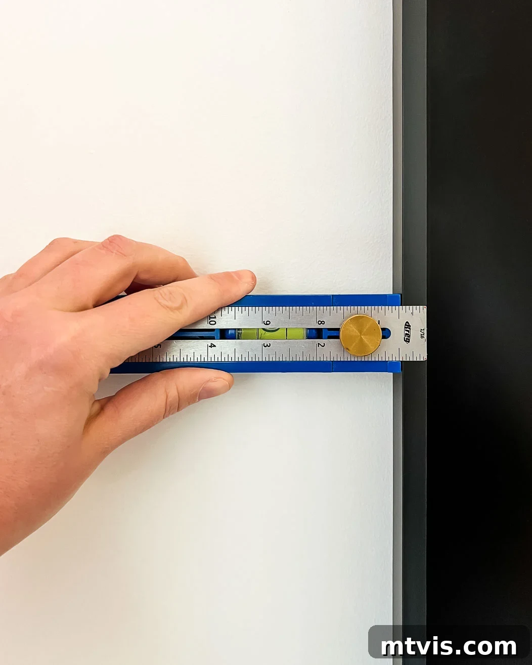 Using a Kreg measuring gauge to measure the TV frame for accurate dimensions