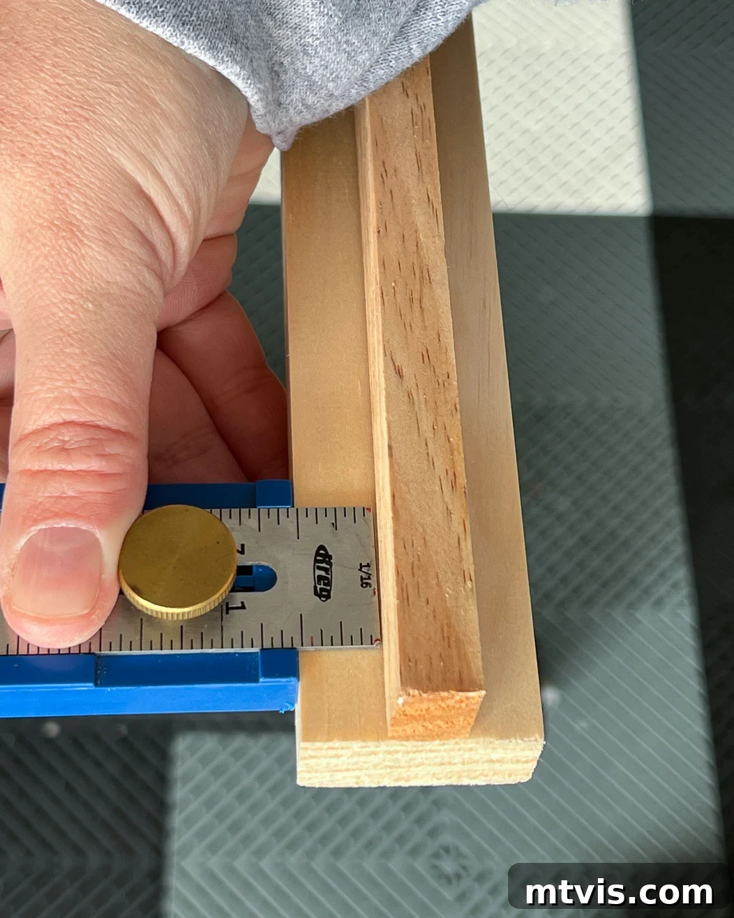 Using Kreg measuring gauge tool to determine precise wood placement for the DIY TV frame assembly