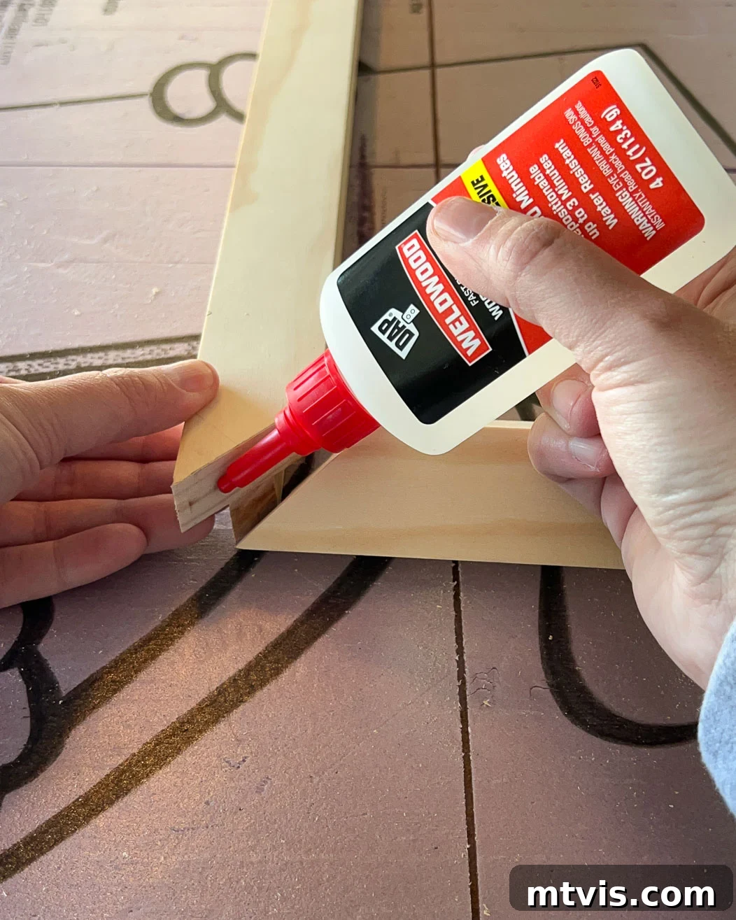 Gluing mitered corners of the wood frame for a television together