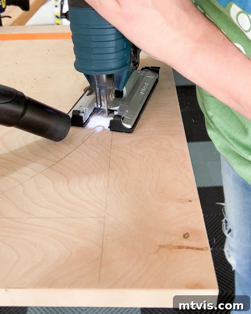 A person skillfully using a jigsaw to cut out an elegant arch shape from a piece of plywood, destined to be part of a custom DIY dog crate.