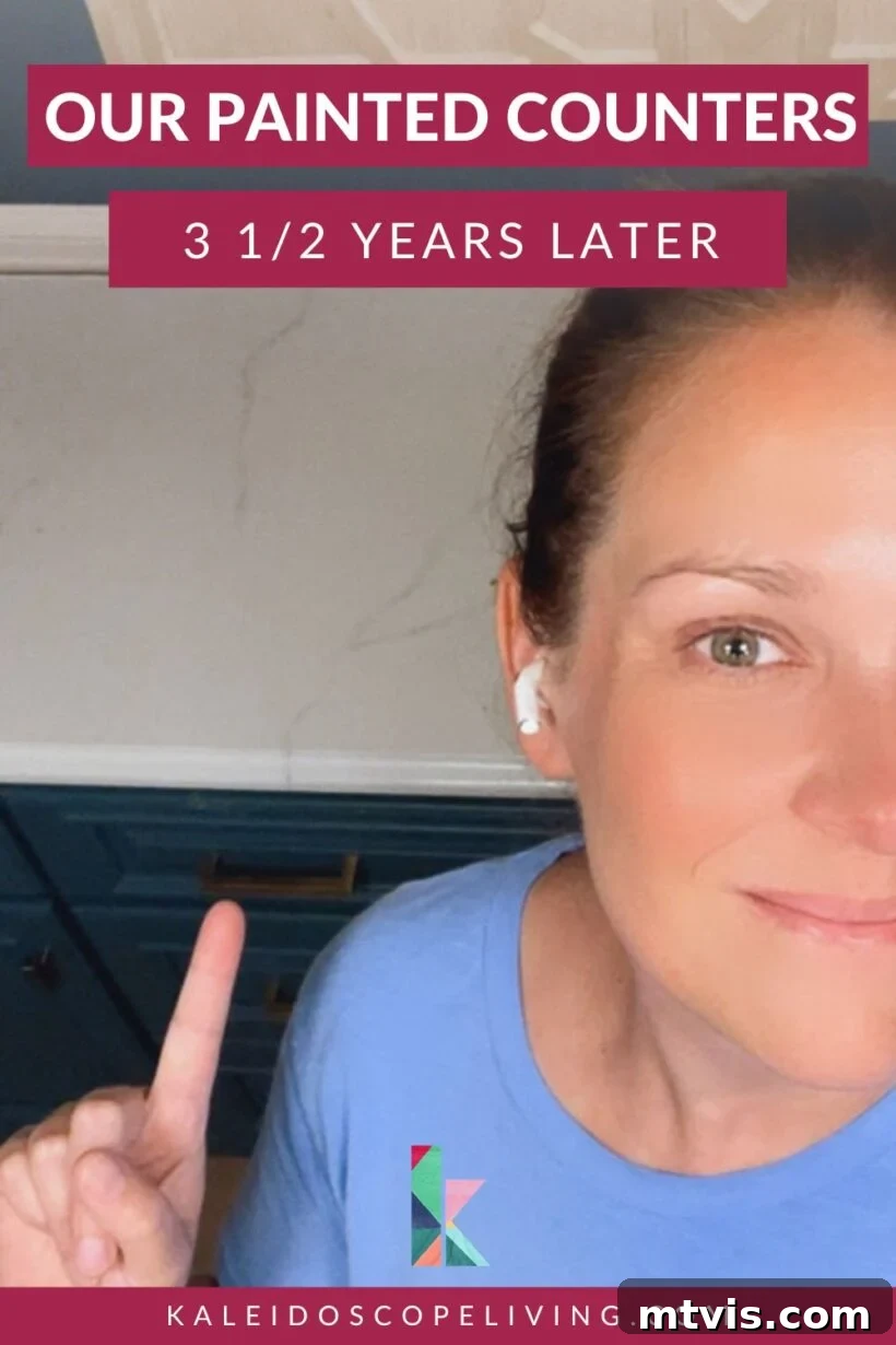 Painted Countertops The Long-Term Review 2 photo of a woman pointing at kitchen countertop with text overlay that reads "our painted counters 3 1/2 years later"