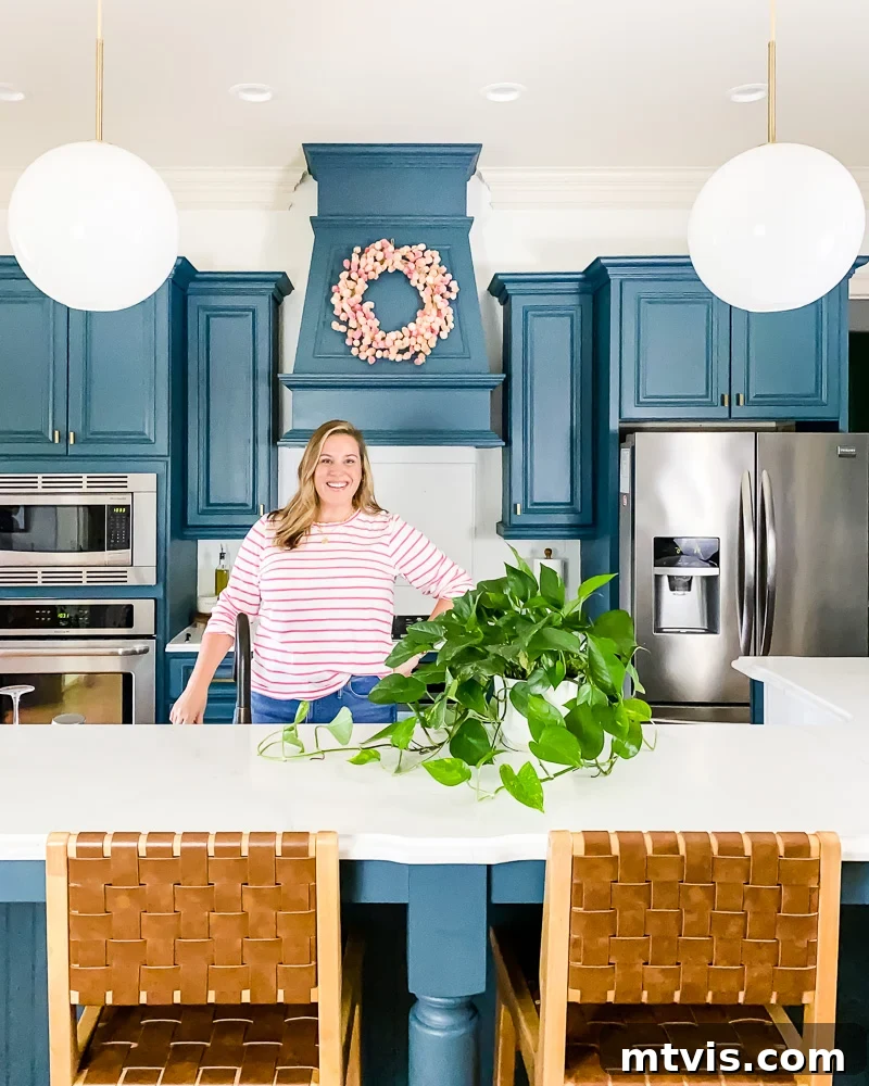 Painted Countertops The Long-Term Review 7 woman standing in kitchen with DIY painted cabinets and countertops