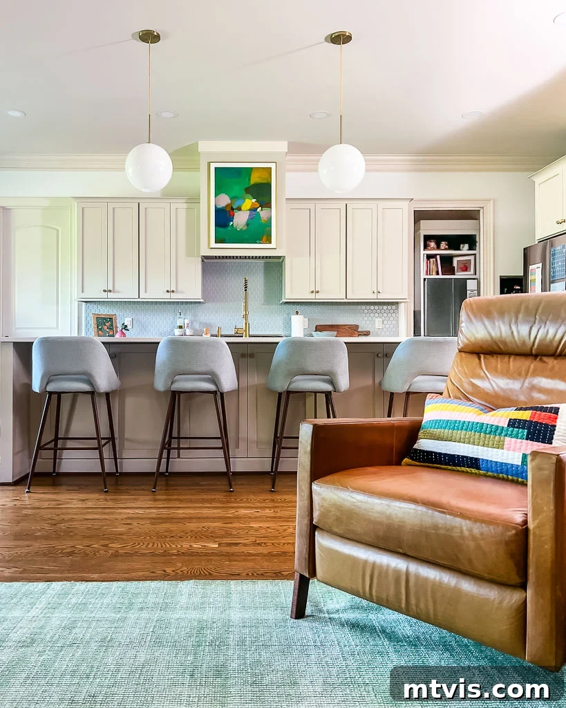 Our Kitchen Reveal: Serene Neutrals, Lively Hues 12 The newly extended kitchen island with added cabinets on the non-working side, maximizing storage and counter space in a neutral kitchen setting.