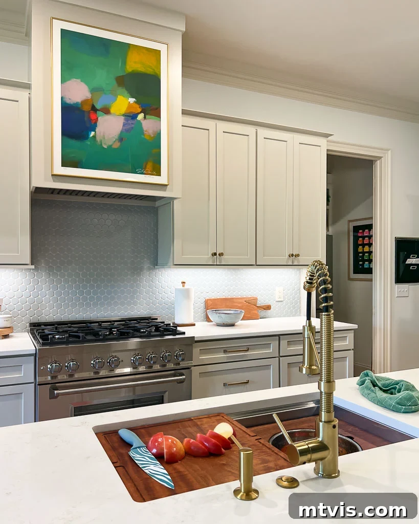 Our Kitchen Reveal: Serene Neutrals, Lively Hues 13 The new workstation sink and modern faucet area, featuring a sleek design and practical setup in the renovated kitchen, reflecting thoughtful choices.