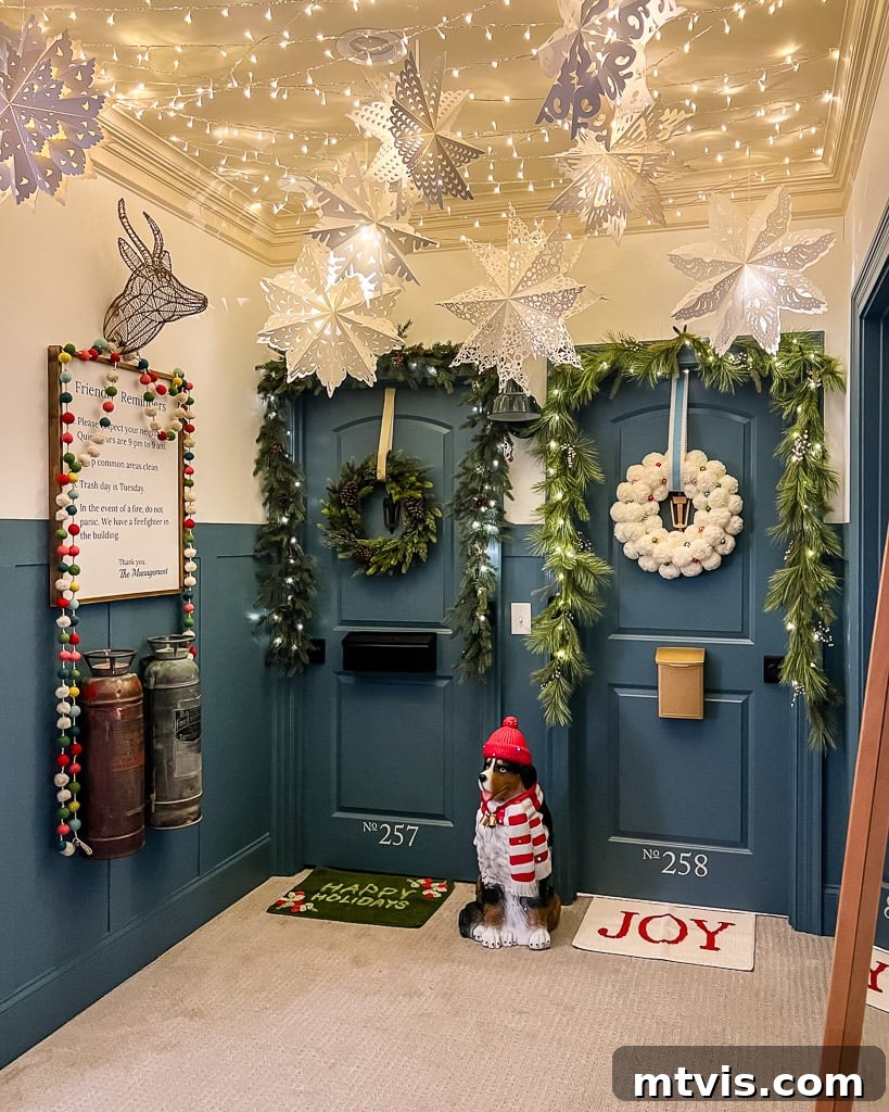 Large light-up paper snowflake lanterns creating a magical Christmas display in a hallway.