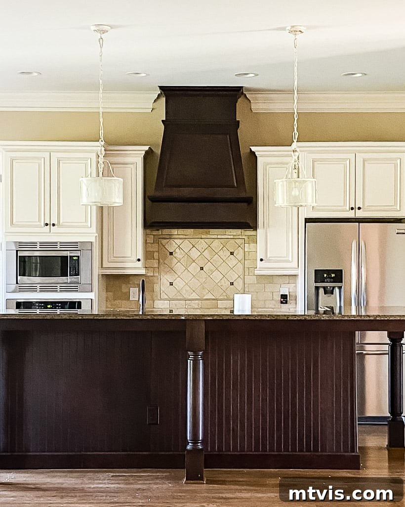 My Triple-Tested Method for Perfectly Painted Kitchen Cabinets 15 outdated kitchen with dark brown island and range hood and cream colored kitchen cabinets before being painted