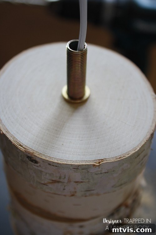 DIY Stacked Wood Lamp: Designer Style on a Budget 11 Securing the threaded pipe into the top wood slice of the lamp base