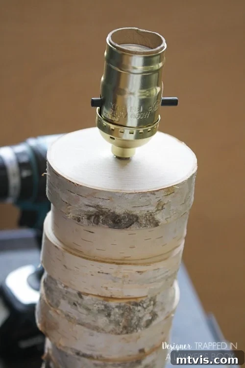 DIY Stacked Wood Lamp: Designer Style on a Budget 15 Securing the lamp socket into the base and pulling excess cord through