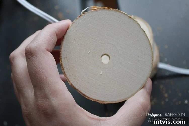 DIY Stacked Wood Lamp: Designer Style on a Budget 9 Drilling a central hole in additional wood slices for stacking