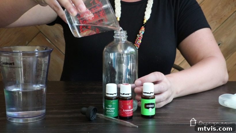 Homemade Botanical Bug Repellent 5 Adding Water to Homemade Bug Spray Mixture