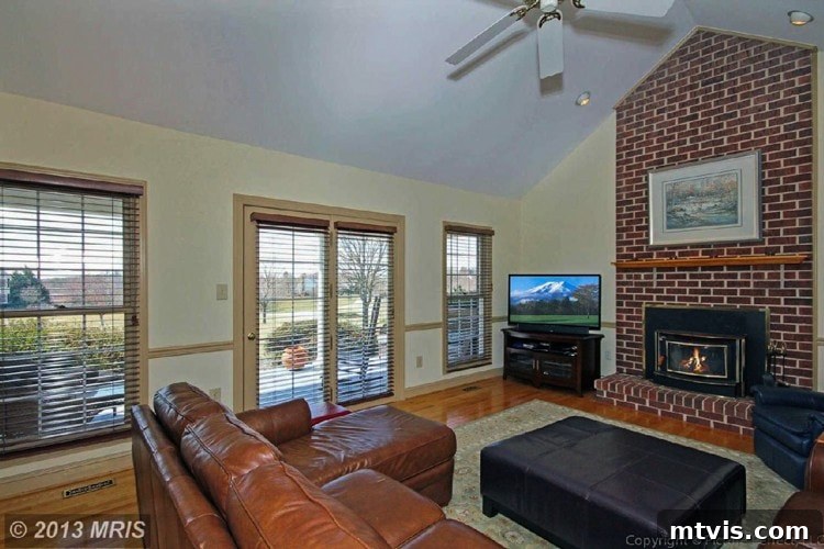Achieve Stunning Ceilings Faux Wood Beam DIY 6 Before image of a family room with high cathedral ceilings, awaiting faux wood beam installation.