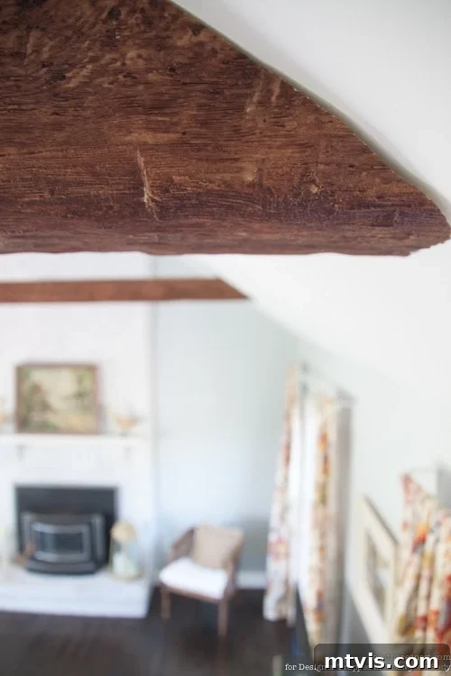 Achieve Stunning Ceilings Faux Wood Beam DIY 9 DIYer cutting a faux wood beam to length and angle using a hand saw.