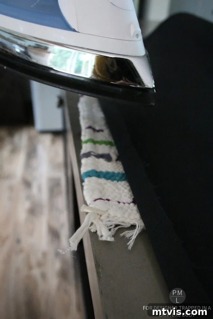 Craft Your Own Hammock Chair 10 Ironing the hem of the duck canvas fabric for the DIY hammock chair's top seam.
